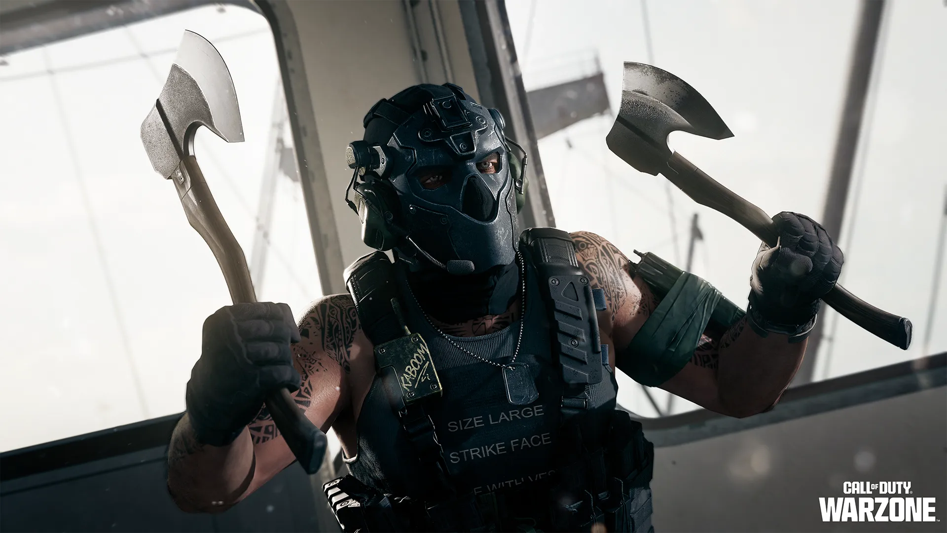 Masked operator raises two tactical hatchets while wearing heavy armor inside a bright structure.