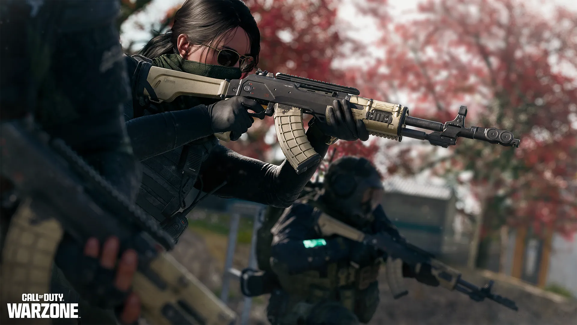 Sunglasses-wearing operator aims an AN-94 rifle from cover with teammates behind her.