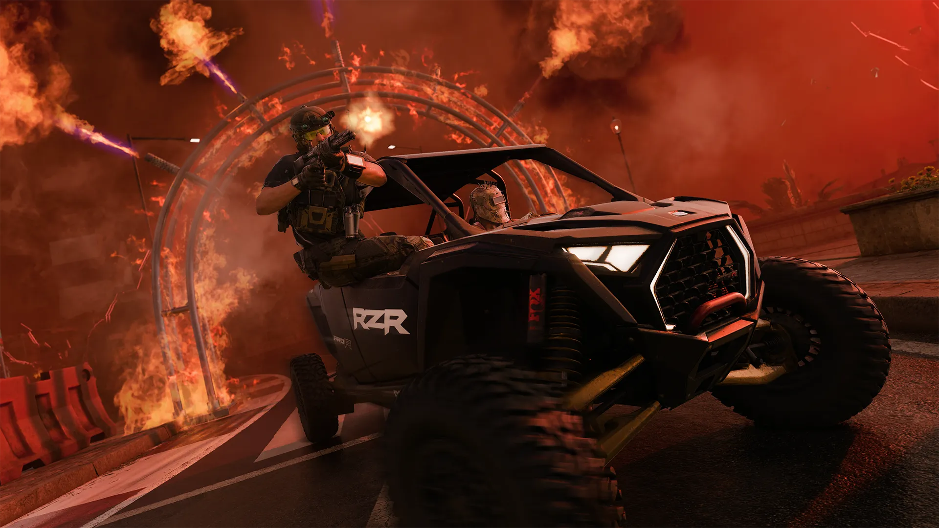 An operator fires from a fast-moving off-road vehicle as flames and explosions erupt across the roadway.