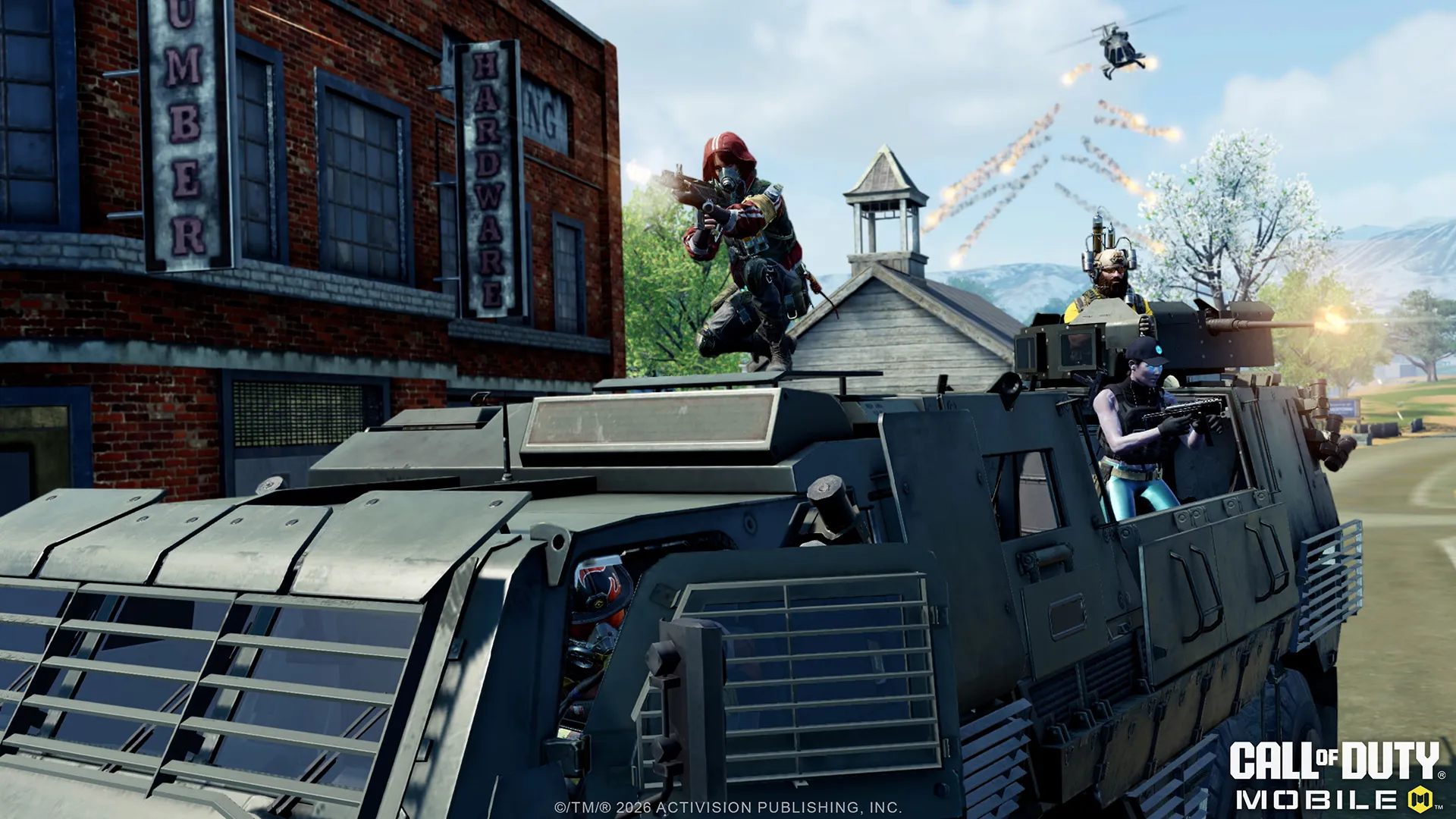 Armed soldiers ride atop a heavy armored vehicle during an intense urban battle.
