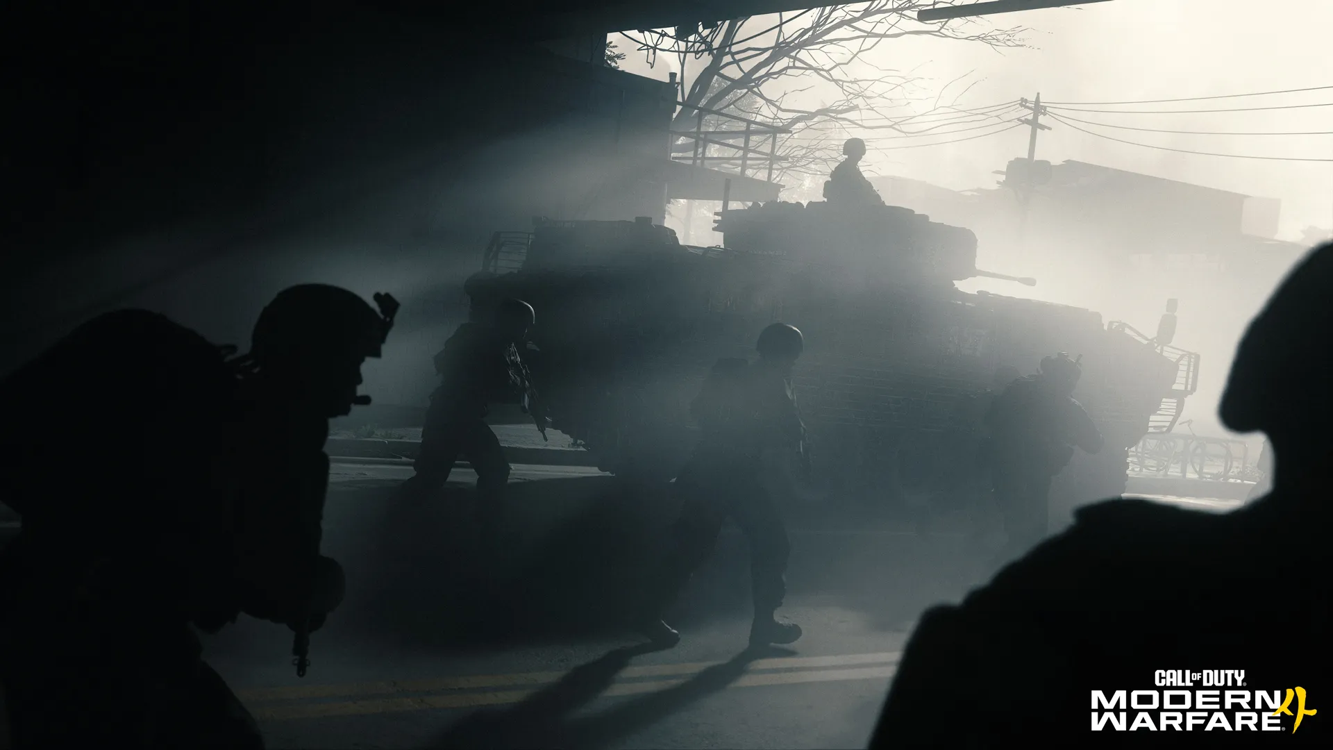 Soldiers move through a hazy street beside a tank silhouetted by bright sunlight.