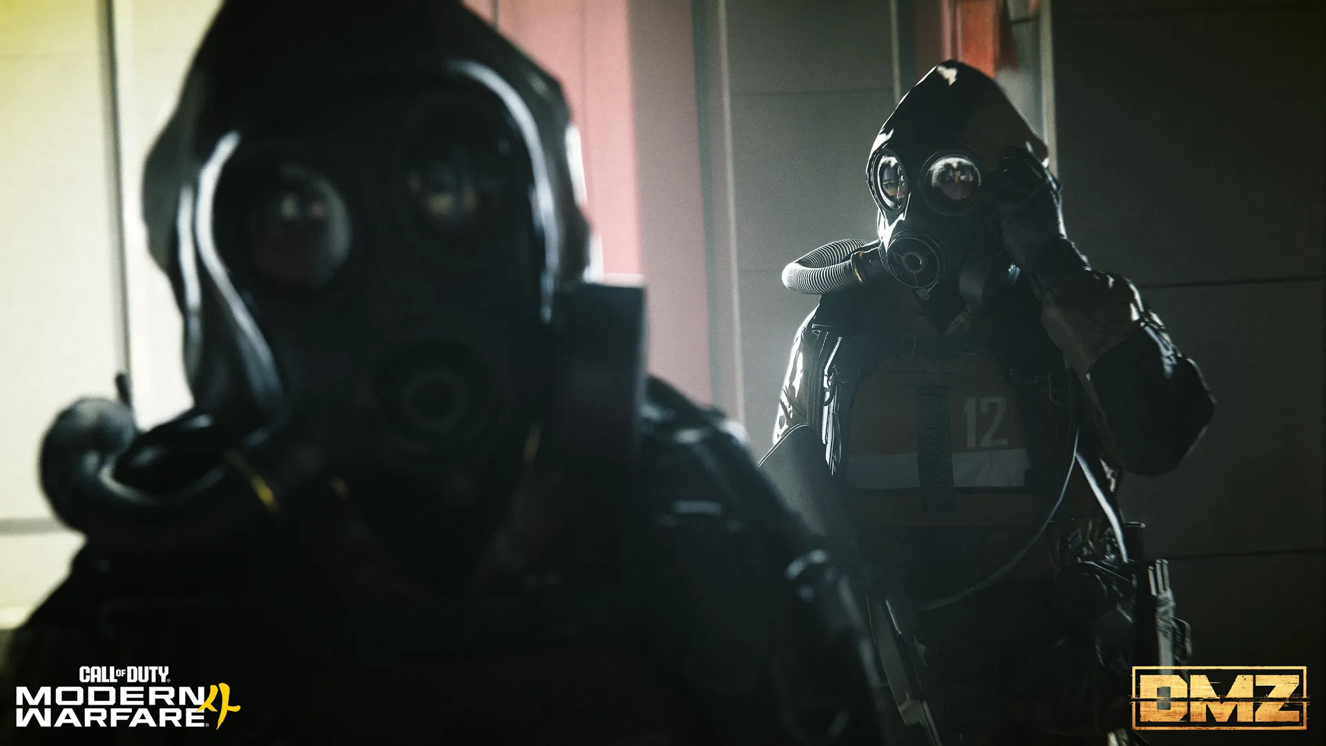 Two gas-masked operators stand in a dim building, one adjusting a headset.