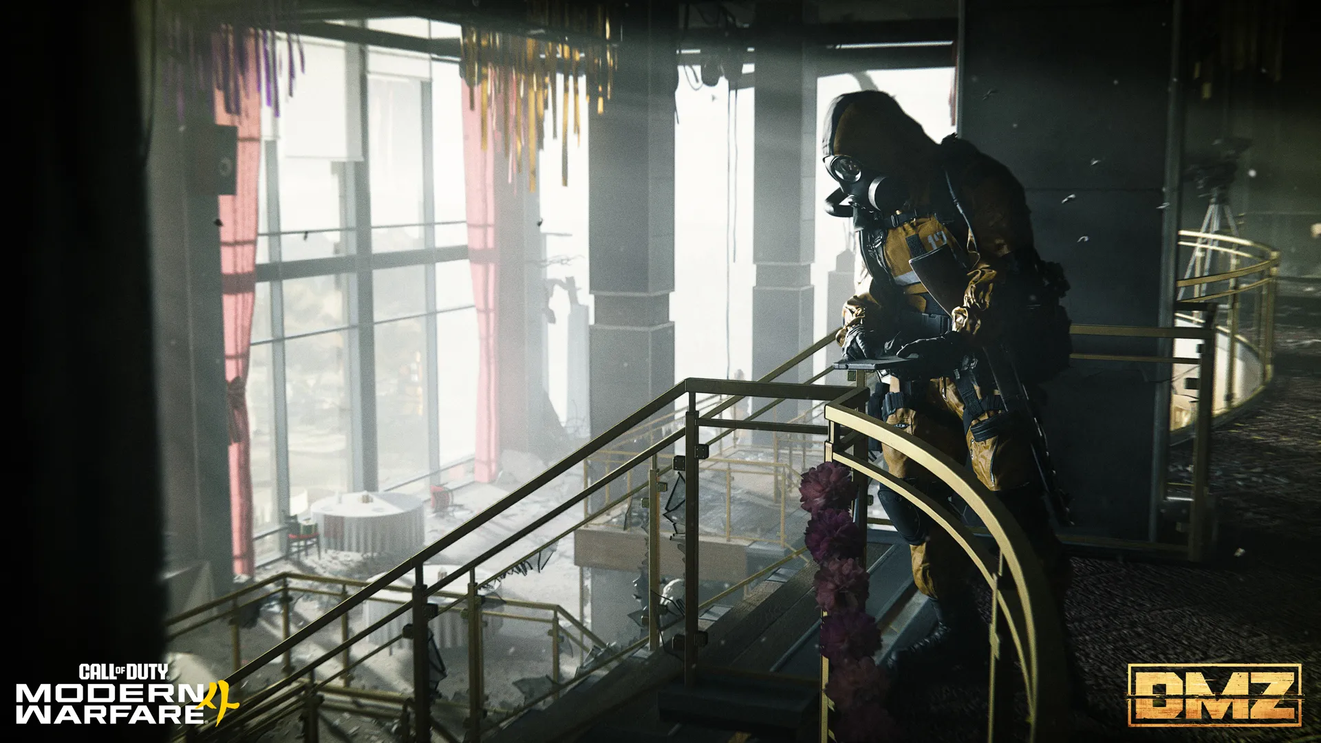 Gas-masked soldier leans over a balcony inside a damaged multi-level building.