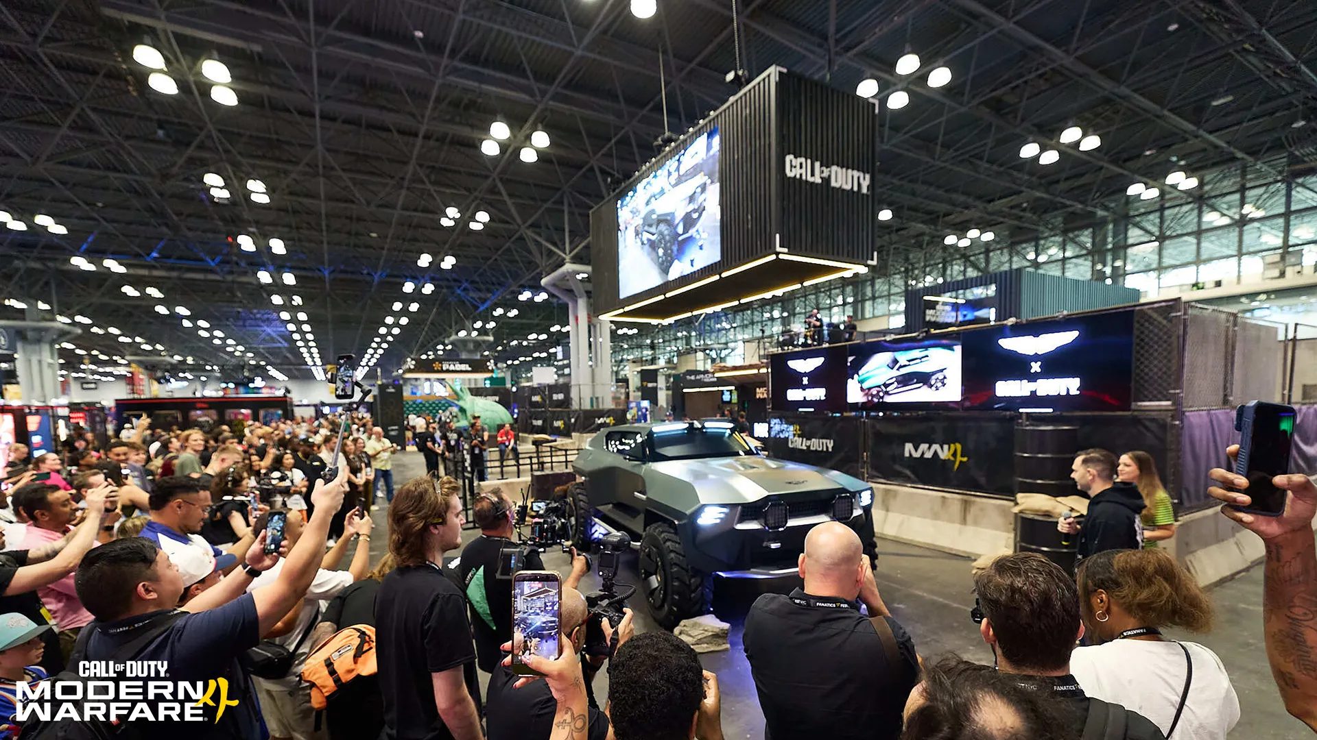 A crowd gathers around the Call of Duty booth as the Aston Martin Dreadnought is shown as a live showcase at a convention.