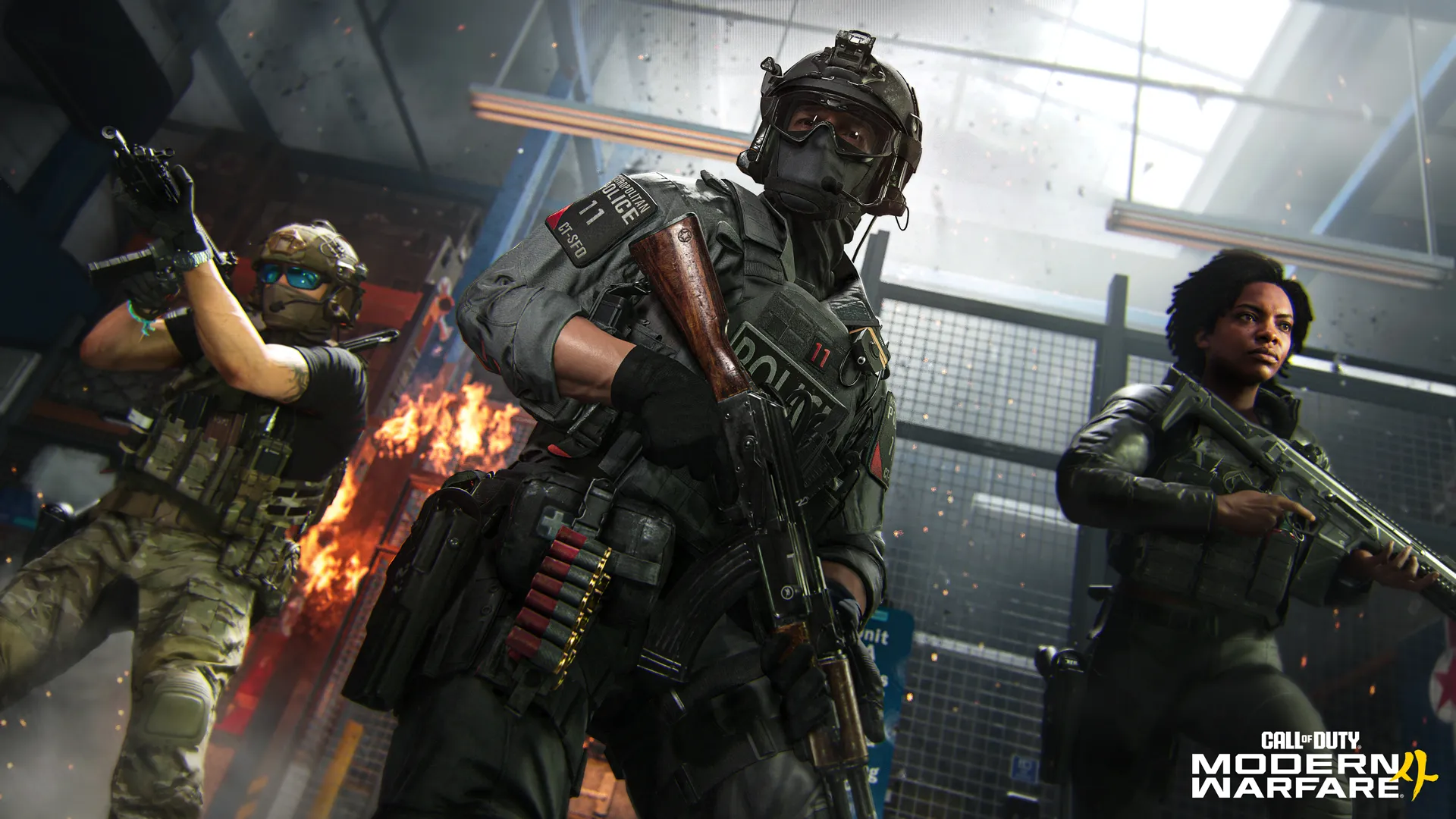 Three operators advance through a burning building, led by a heavily armored Operator carrying a rifle.