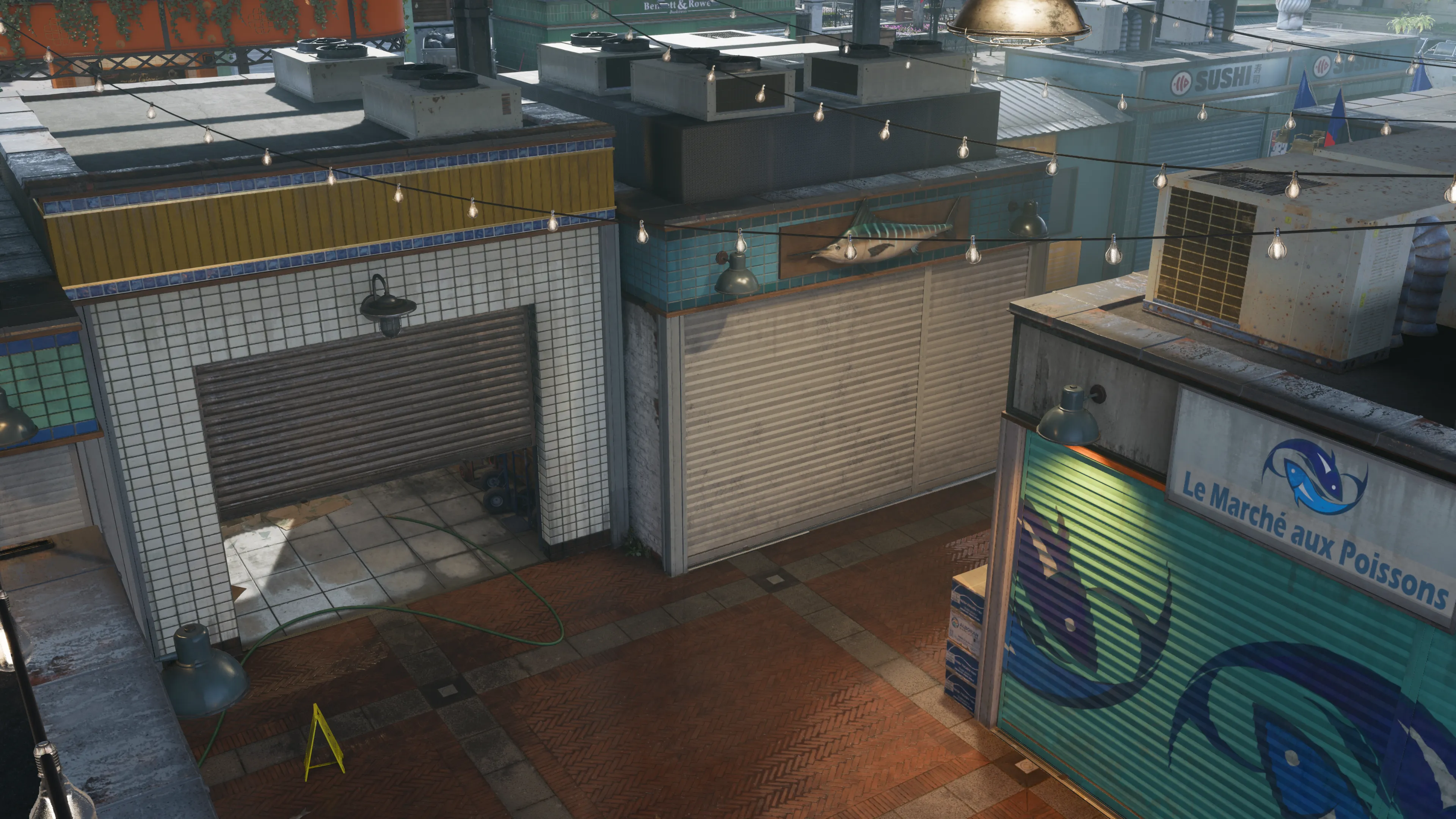 An open delivery zone with lights above and crates stands between tight stalls. (Alt-text generated by ChatGPT)