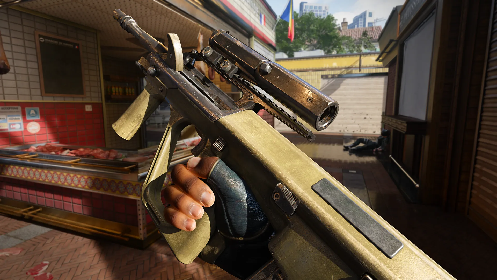A close-up view of an olive green assault rifle with a scope, held by a gloved hand inside a butcher shop with meat counters. The gun shows wear, suggesting heavy use. (Description by ChatGPT)