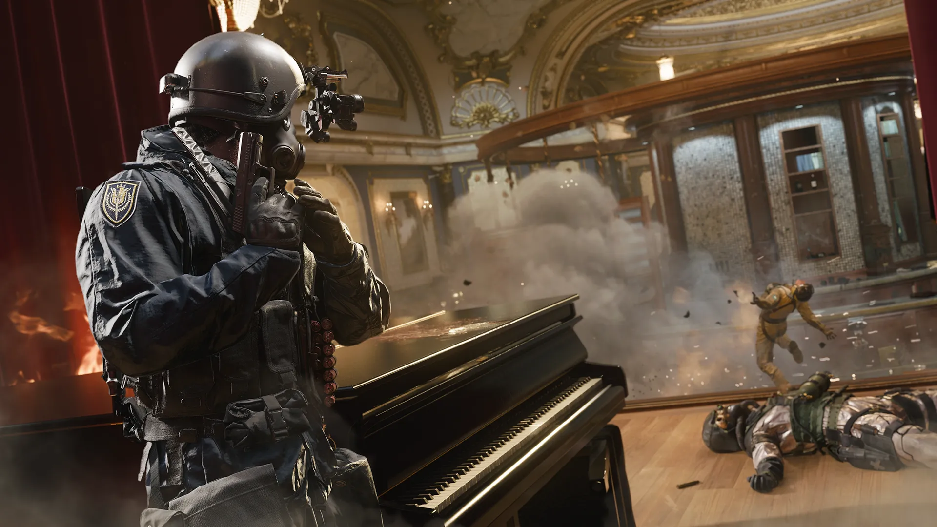 A masked soldier in tactical gear stands beside a grand piano as an explosion erupts across the casino floor, sending a soldier flying through the smoke and debris under an ornate, gold-trimmed ceiling.